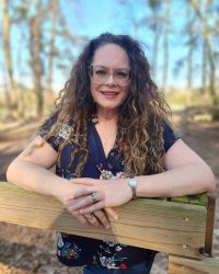 Jenn 2025 leaning on fence